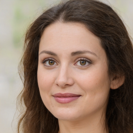 Joyful white young-adult female with long  brown hair and green eyes