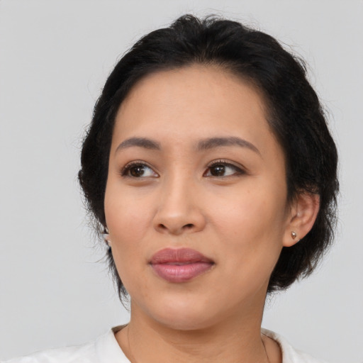 Joyful latino young-adult female with medium  black hair and brown eyes