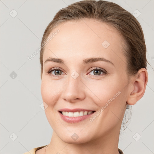 Joyful white young-adult female with medium  brown hair and grey eyes