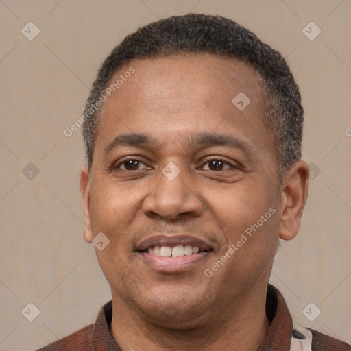 Joyful latino adult male with short  black hair and brown eyes