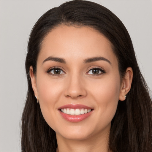 Joyful white young-adult female with long  brown hair and brown eyes