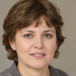 Joyful white adult female with medium  brown hair and grey eyes