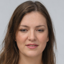 Joyful white young-adult female with long  brown hair and grey eyes