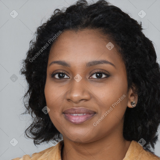 Joyful black young-adult female with long  black hair and brown eyes