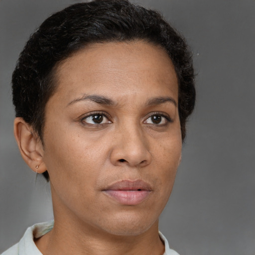 Neutral latino adult female with short  brown hair and brown eyes