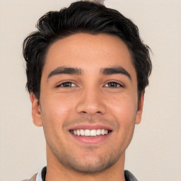 Joyful white young-adult male with short  black hair and brown eyes