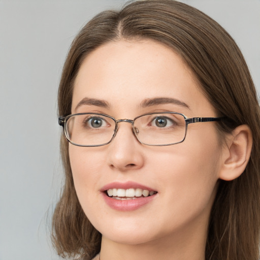 Joyful white young-adult female with long  brown hair and grey eyes