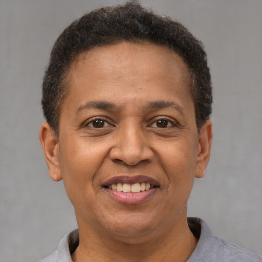 Joyful latino adult female with short  brown hair and brown eyes