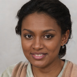 Joyful black young-adult female with medium  brown hair and brown eyes