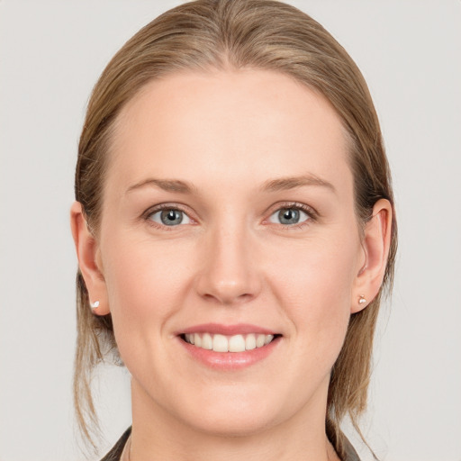 Joyful white young-adult female with long  brown hair and blue eyes