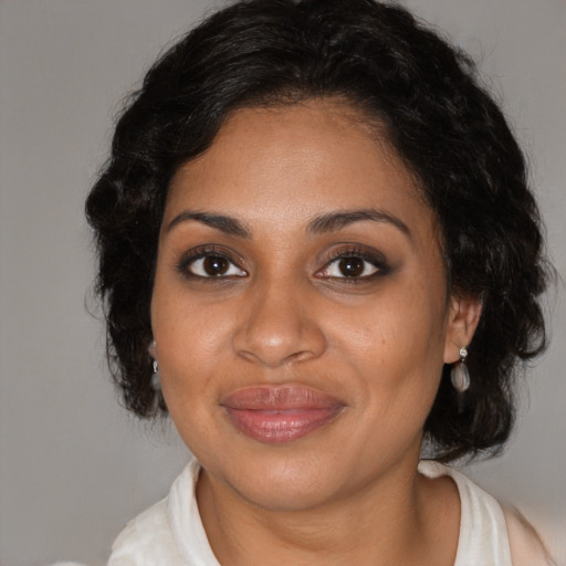 Joyful black adult female with medium  black hair and brown eyes