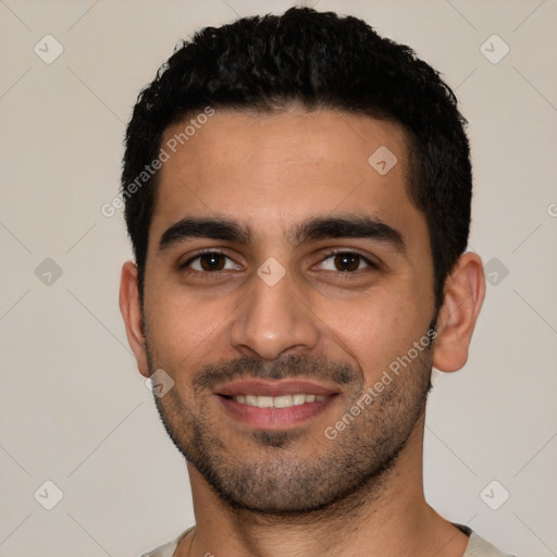 Joyful latino young-adult male with short  black hair and brown eyes