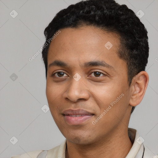 Joyful latino young-adult male with short  black hair and brown eyes