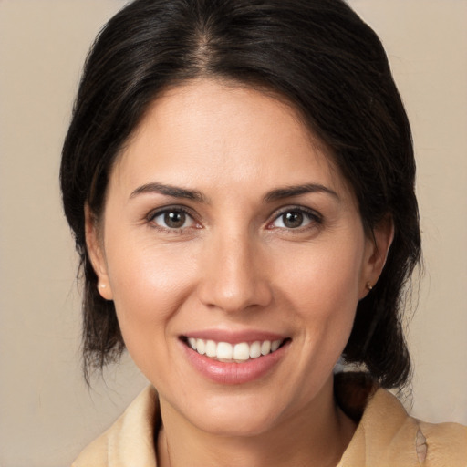 Joyful white young-adult female with medium  brown hair and brown eyes