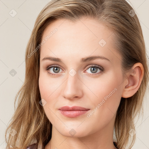 Joyful white young-adult female with long  brown hair and blue eyes