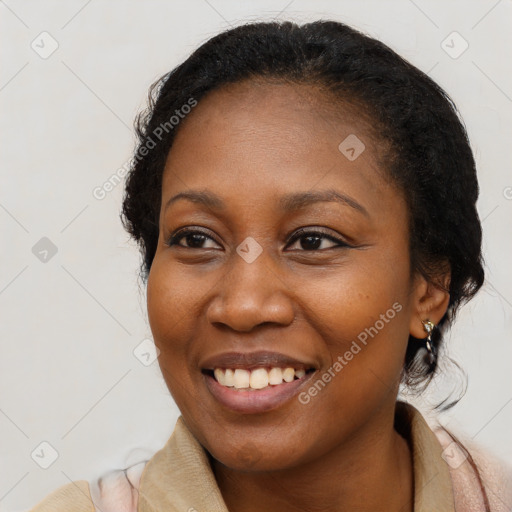 Joyful black young-adult female with medium  black hair and brown eyes