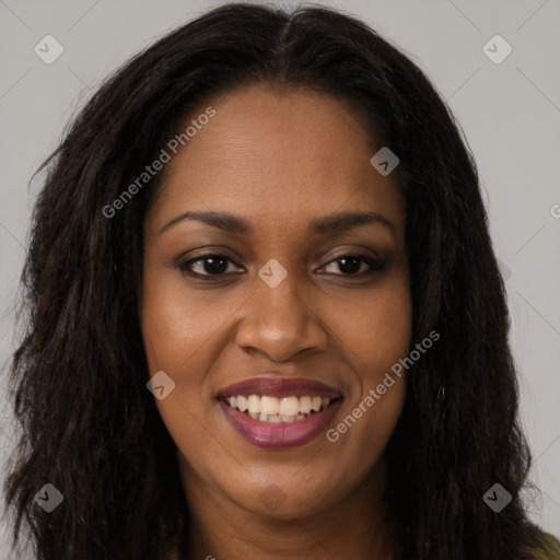 Joyful black young-adult female with long  brown hair and brown eyes