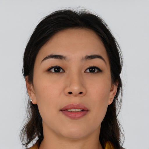 Joyful asian young-adult female with long  brown hair and brown eyes