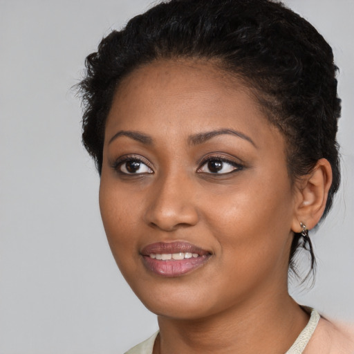 Joyful black young-adult female with medium  brown hair and brown eyes