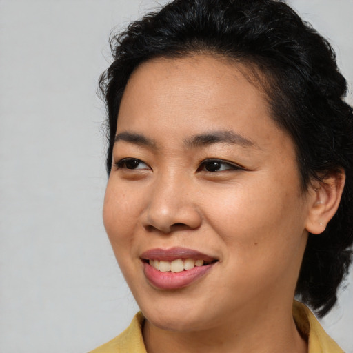 Joyful asian young-adult female with medium  brown hair and brown eyes