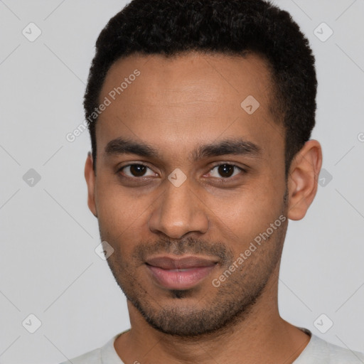 Joyful black young-adult male with short  black hair and brown eyes