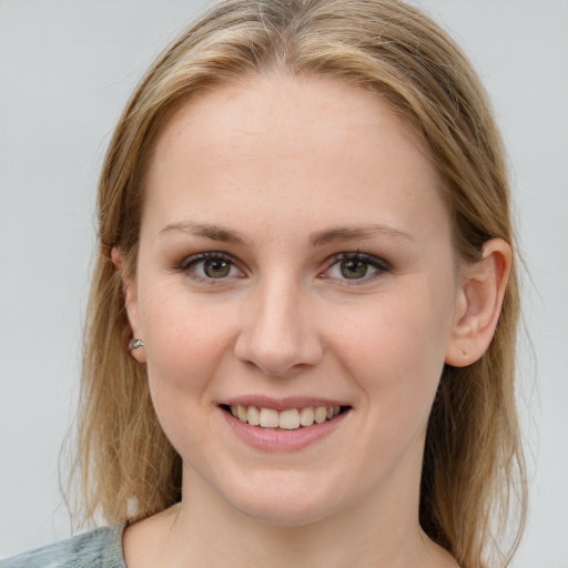 Joyful white young-adult female with medium  brown hair and blue eyes