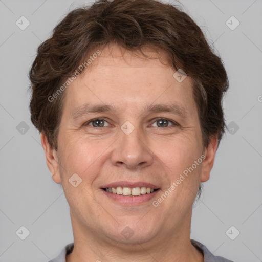 Joyful white adult male with short  brown hair and grey eyes