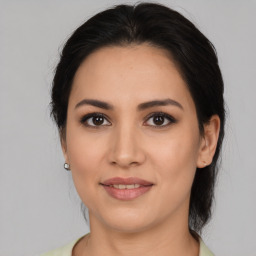 Joyful white young-adult female with medium  brown hair and brown eyes