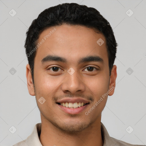 Joyful latino young-adult male with short  black hair and brown eyes