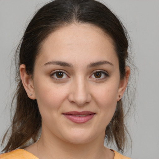 Joyful white young-adult female with medium  brown hair and brown eyes