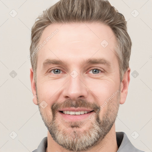 Joyful white adult male with short  brown hair and grey eyes