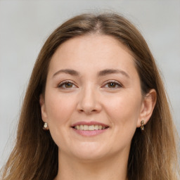 Joyful white young-adult female with long  brown hair and brown eyes