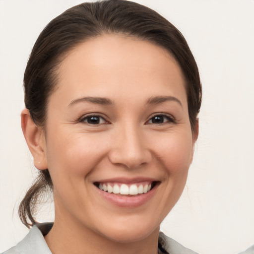 Joyful white young-adult female with medium  brown hair and brown eyes