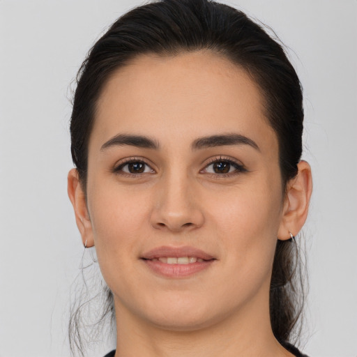 Joyful white young-adult female with long  brown hair and brown eyes