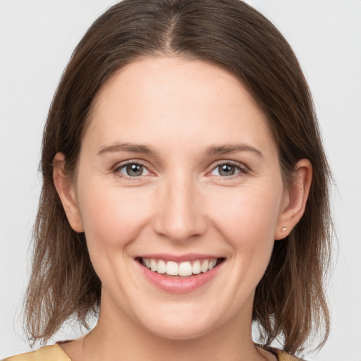 Joyful white young-adult female with medium  brown hair and brown eyes