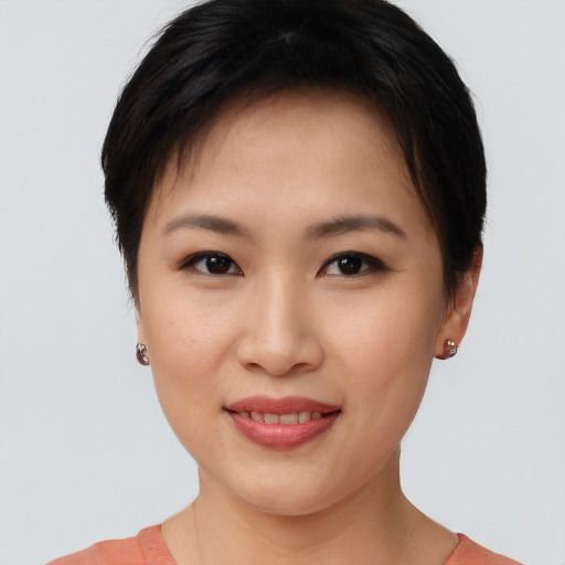 Joyful asian young-adult female with short  brown hair and brown eyes