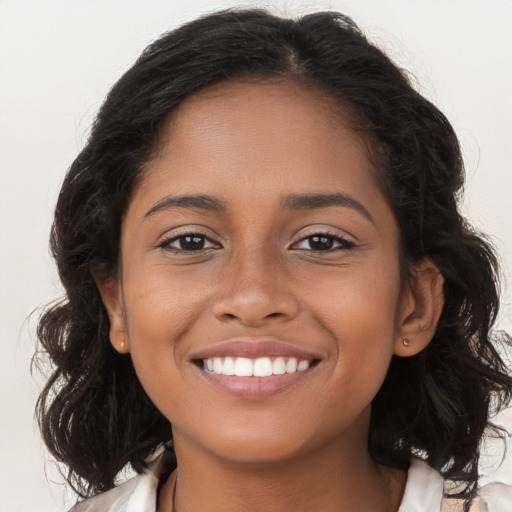 Joyful latino young-adult female with long  brown hair and brown eyes