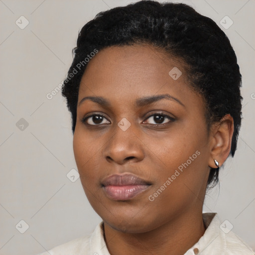 Joyful black young-adult female with short  black hair and brown eyes