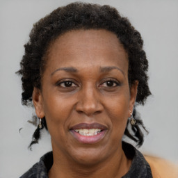 Joyful black adult female with short  brown hair and brown eyes