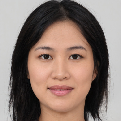 Joyful asian young-adult female with medium  black hair and brown eyes