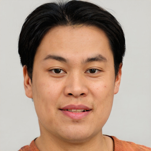 Joyful asian young-adult male with short  brown hair and brown eyes