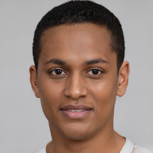 Joyful black young-adult male with short  brown hair and brown eyes
