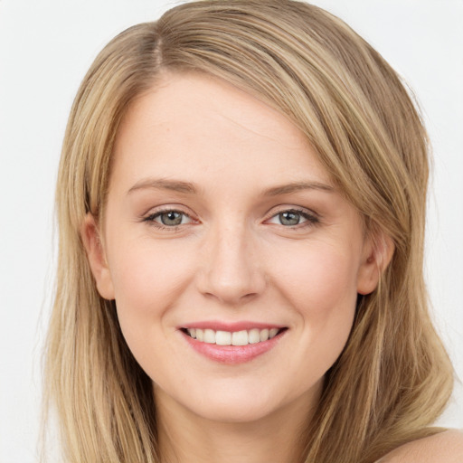 Joyful white young-adult female with long  brown hair and green eyes