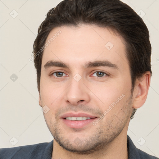 Joyful white young-adult male with short  brown hair and brown eyes