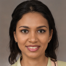 Joyful black young-adult female with medium  brown hair and brown eyes