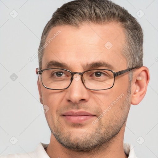 Joyful white adult male with short  brown hair and brown eyes