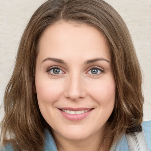 Joyful white young-adult female with medium  brown hair and green eyes