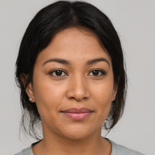 Joyful asian young-adult female with medium  brown hair and brown eyes