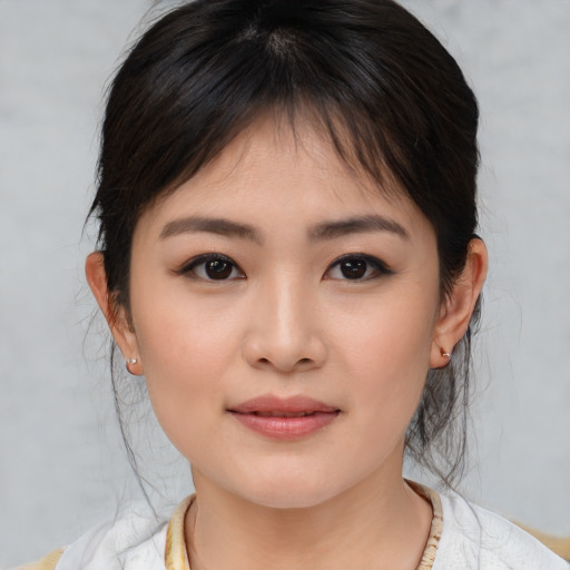 Joyful asian young-adult female with medium  brown hair and brown eyes
