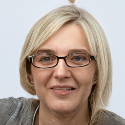 Joyful white adult female with medium  brown hair and blue eyes